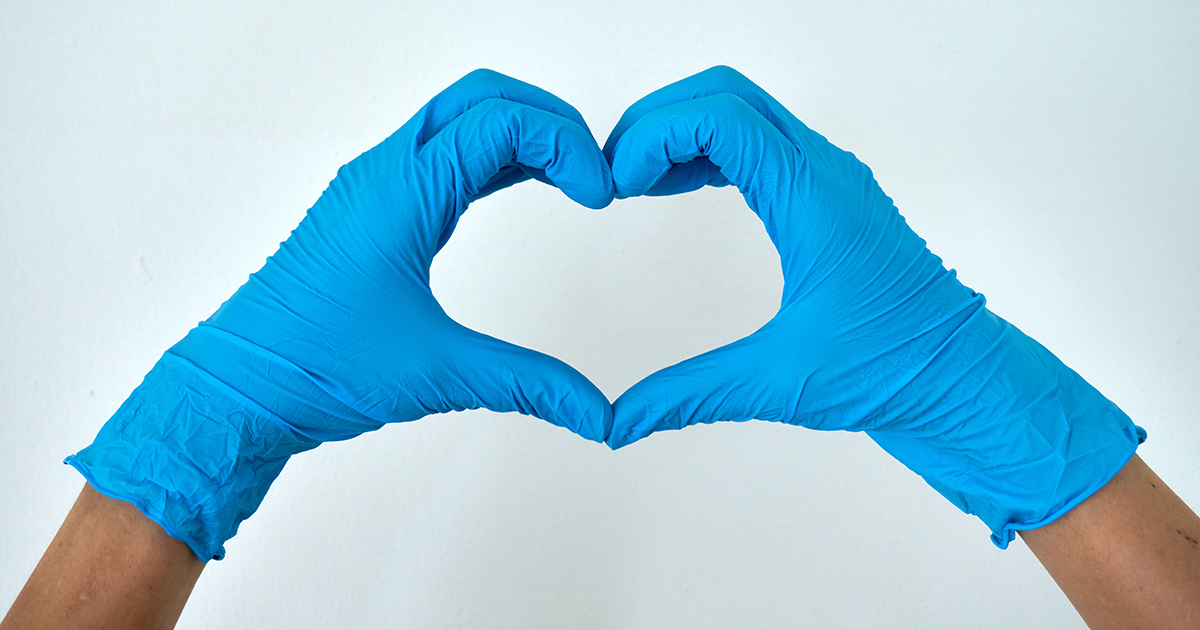 Gloved hands make heart shape