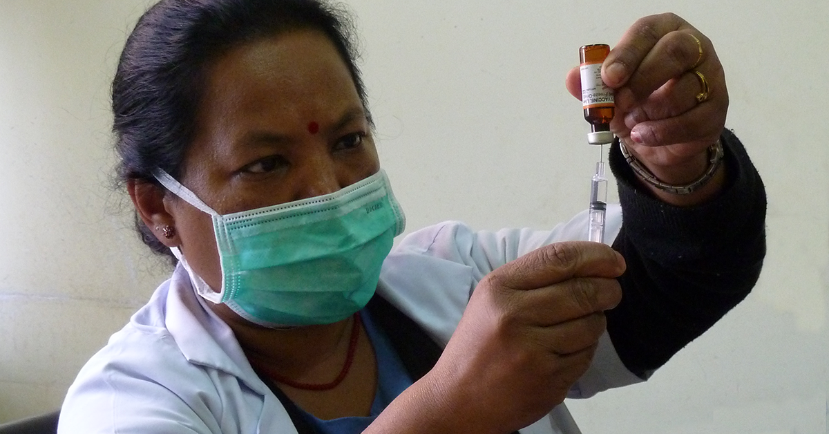 Nepal health professional prepares vaccine