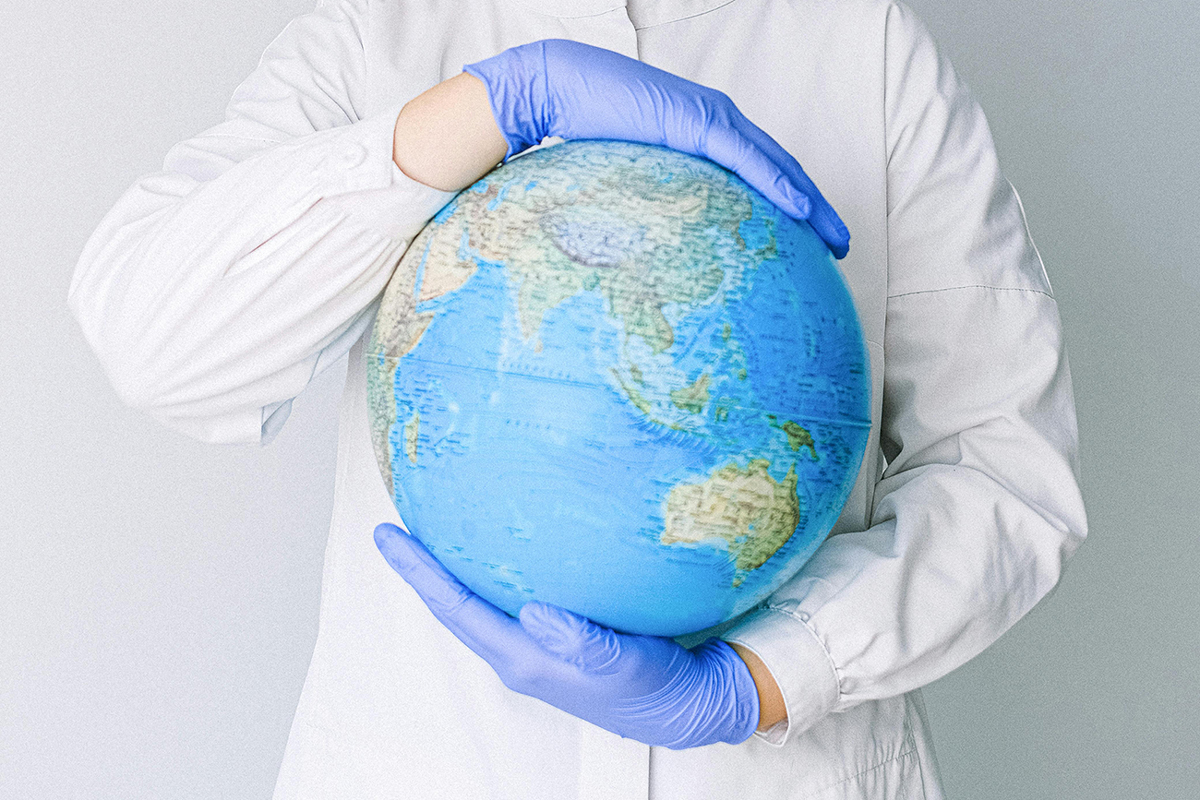 Health care clinician holding a globe Health care clinician holding a globe