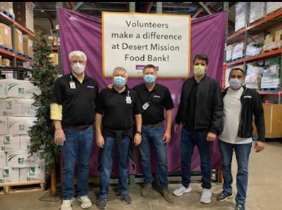 HonorHealth team standing in front of food donations at a food bank