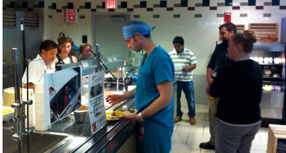 Physician purchasing fish in cafeteria 