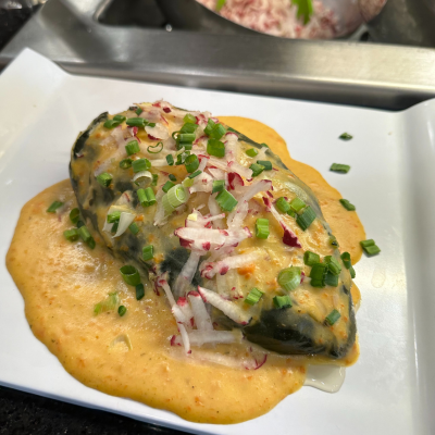 Stuffed poblano pepper with ancho chile carrot sauce