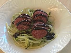 Baked "beetballs" with pesto zucchini noodles and balsamic glaze