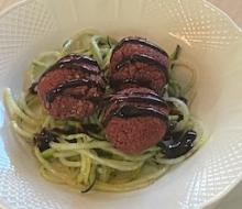Baked "beetballs" with pesto zucchini noodles and balsamic glaze